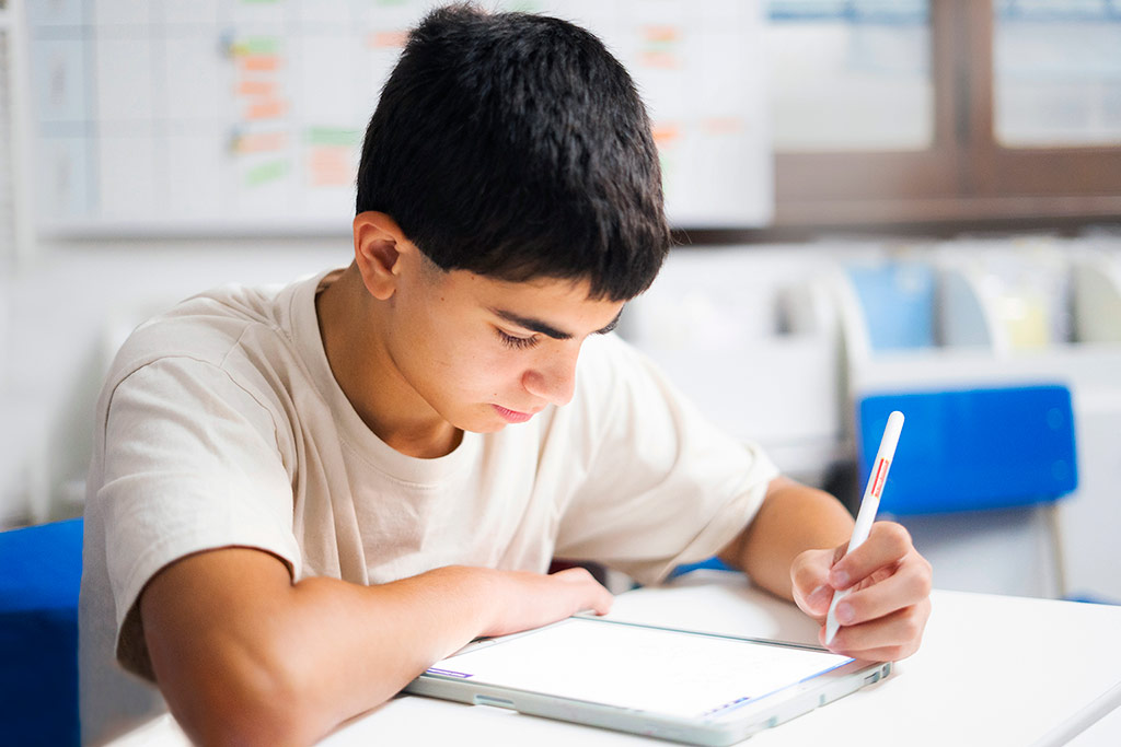 Estudiante concentrada resolviendo ejercicios en papel como parte del método Kumon de estudio individualizado-Chile